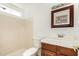 Simple bathroom featuring a sink with wood cabinets and a shower-tub combination at 3222 W Wagoner Rd, Phoenix, AZ 85053