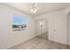 Bedroom featuring tile floors, a ceiling fan, and a large window overlooking the street at 3222 W Wagoner Rd, Phoenix, AZ 85053