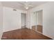 Bedroom with hardwood floors, ceiling fan, and access to an attached bathroom through a doorway at 3222 W Wagoner Rd, Phoenix, AZ 85053