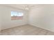Bright bedroom with tile floors, a ceiling fan, and a window providing ample natural light at 3222 W Wagoner Rd, Phoenix, AZ 85053