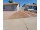 Well-maintained single-story home featuring low maintenance desert landscaping and a concrete driveway at 3222 W Wagoner Rd, Phoenix, AZ 85053