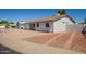 Exterior view of the house with driveway and low maintenance desert landscaping, perfect for easy care at 3222 W Wagoner Rd, Phoenix, AZ 85053