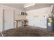 Attached garage featuring water heater, storage shelving and work bench at 3222 W Wagoner Rd, Phoenix, AZ 85053