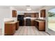 The remodeled kitchen has granite countertops, wood cabinets, black appliances, and tile flooring, which is easy to clean at 3222 W Wagoner Rd, Phoenix, AZ 85053