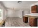 Open kitchen area flowing into the living room, featuring granite counters, wood cabinets, and tile floors at 3222 W Wagoner Rd, Phoenix, AZ 85053