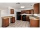 Functional kitchen featuring granite counters, wood cabinets, black appliances, and an eat-in counter space at 3222 W Wagoner Rd, Phoenix, AZ 85053