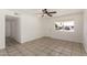 The living room has tile flooring, white walls, and is illuminated by natural light, along with a ceiling fan at 3222 W Wagoner Rd, Phoenix, AZ 85053