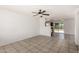 Bright living room with tile flooring, ceiling fan, and an open floor plan to the kitchen and backyard access at 3222 W Wagoner Rd, Phoenix, AZ 85053