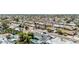 Aerial view showcases a neighborhood with mature trees, varied rooftops, and community pools in several backyards at 4020 W Anderson Dr, Glendale, AZ 85308