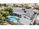 Aerial view of the home featuring a large backyard pool, mature trees, and an ample patio space at 4020 W Anderson Dr, Glendale, AZ 85308