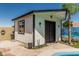 Backyard shed with a painted mural, window, and double-door entry, set on a stone tiled patio at 4020 W Anderson Dr, Glendale, AZ 85308