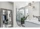 A view of a bathroom with marble floors, a glass-enclosed shower, and modern fixtures at 4020 W Anderson Dr, Glendale, AZ 85308
