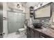 Stylish bathroom featuring a vessel sink, dark wood vanity, and tiled walk-in shower at 4020 W Anderson Dr, Glendale, AZ 85308