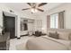 Cozy bedroom with white walls, modern ceiling fan, and a closet with open storage at 4020 W Anderson Dr, Glendale, AZ 85308