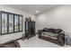 Bright room featuring white tile flooring, a black chest of drawers, and a comfortable chaise lounge at 4020 W Anderson Dr, Glendale, AZ 85308