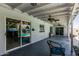 The covered patio features ceiling fans, neutral-toned flooring, with views of the lush backyard and pool at 4020 W Anderson Dr, Glendale, AZ 85308