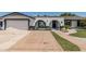Inviting single-story home featuring a brick driveway and arched entryway with lovely landscaping and curb appeal at 4020 W Anderson Dr, Glendale, AZ 85308