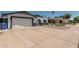Charming single-story home with a wide driveway, arched entryway, and well-maintained landscaping at 4020 W Anderson Dr, Glendale, AZ 85308