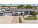 Charming home showcasing landscaped front yard, decorative stone, arched entry, and spacious driveway at 4020 W Anderson Dr, Glendale, AZ 85308