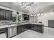 Modern kitchen features black cabinets, stainless steel appliances, and stylish stone backsplash at 4020 W Anderson Dr, Glendale, AZ 85308