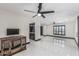 Bright living room showcases white tile floors and an open layout to the updated kitchen at 4020 W Anderson Dr, Glendale, AZ 85308