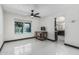 Bright living room showcases white tile floors and an open layout to the updated kitchen at 4020 W Anderson Dr, Glendale, AZ 85308