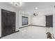 Spacious living room features bright white tile floors, modern fan, and view of front yard at 4020 W Anderson Dr, Glendale, AZ 85308