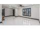 Bright living room showcases white tile floors, black window trim and modern ceiling fan at 4020 W Anderson Dr, Glendale, AZ 85308