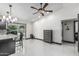 Living area featuring a ceiling fan, white floors and walls, closet for storage, and access to the yard at 4020 W Anderson Dr, Glendale, AZ 85308