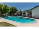 Backyard pool and lush landscaping with an outdoor bar, offering a serene and private outdoor space at 4020 W Anderson Dr, Glendale, AZ 85308