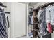 Organized walk-in closet with wooden shelves and rods, offering ample storage space at 4020 W Anderson Dr, Glendale, AZ 85308