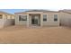 View of the house backyard area with block wall and patio area ready for landscaping at 5688 S 243Rd Dr, Buckeye, AZ 85326