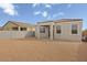 View of the house backyard featuring block wall and patio area ready for landscaping at 5688 S 243Rd Dr, Buckeye, AZ 85326