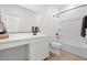 Bright bathroom featuring a white vanity, large mirror, and a shower-tub combination at 5688 S 243Rd Dr, Buckeye, AZ 85326