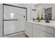 Modern bathroom featuring a dual vanity, and a glass-enclosed walk-in shower at 5688 S 243Rd Dr, Buckeye, AZ 85326