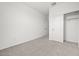 Clean, carpeted bedroom with a closet, white walls, and a doorway leading to another room at 5688 S 243Rd Dr, Buckeye, AZ 85326