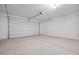 Spacious garage with a concrete floor and an automatic overhead door at 5688 S 243Rd Dr, Buckeye, AZ 85326