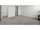 Carpeted main bedroom with a door to the bathroom and a light color palette at 5688 S 243Rd Dr, Buckeye, AZ 85326