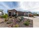 House exterior showcasing desert landscaping and a two-car garage at 26935 W Zachary Dr, Buckeye, AZ 85396