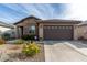 Single-story home with stone accents and a two-car garage at 26935 W Zachary Dr, Buckeye, AZ 85396