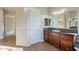 Bathroom with dark wood cabinets and granite countertop at 1681 E Grand Ridge Rd, Queen Creek, AZ 85140