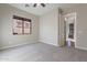 Bright bedroom with carpet flooring and an ensuite bathroom at 1681 E Grand Ridge Rd, Queen Creek, AZ 85140