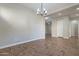 Elegant dining room with tile floor and a modern chandelier at 1681 E Grand Ridge Rd, Queen Creek, AZ 85140