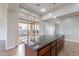 Kitchen features a large island with granite countertops and pendant lighting at 1681 E Grand Ridge Rd, Queen Creek, AZ 85140