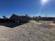 Large backyard with gravel and a view of the house at 12438 N 111Th Ave, Youngtown, AZ 85363