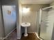 Bathroom with pedestal sink and shower at 12438 N 111Th Ave, Youngtown, AZ 85363