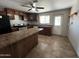 View of kitchen with wood cabinets and tiled floor at 12438 N 111Th Ave, Youngtown, AZ 85363