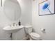 Chic half bathroom features a pedestal sink, modern fixtures, and elegant decor at 2511 W Queen Creek Rd # 179, Chandler, AZ 85248