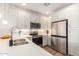 Elegant kitchen features white cabinetry, stainless steel appliances, and quartz countertops at 2511 W Queen Creek Rd # 179, Chandler, AZ 85248