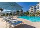 Inviting community pool with lounge chairs and umbrellas for relaxation at 2511 W Queen Creek Rd # 179, Chandler, AZ 85248